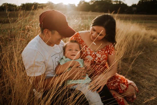 Family sitting in field