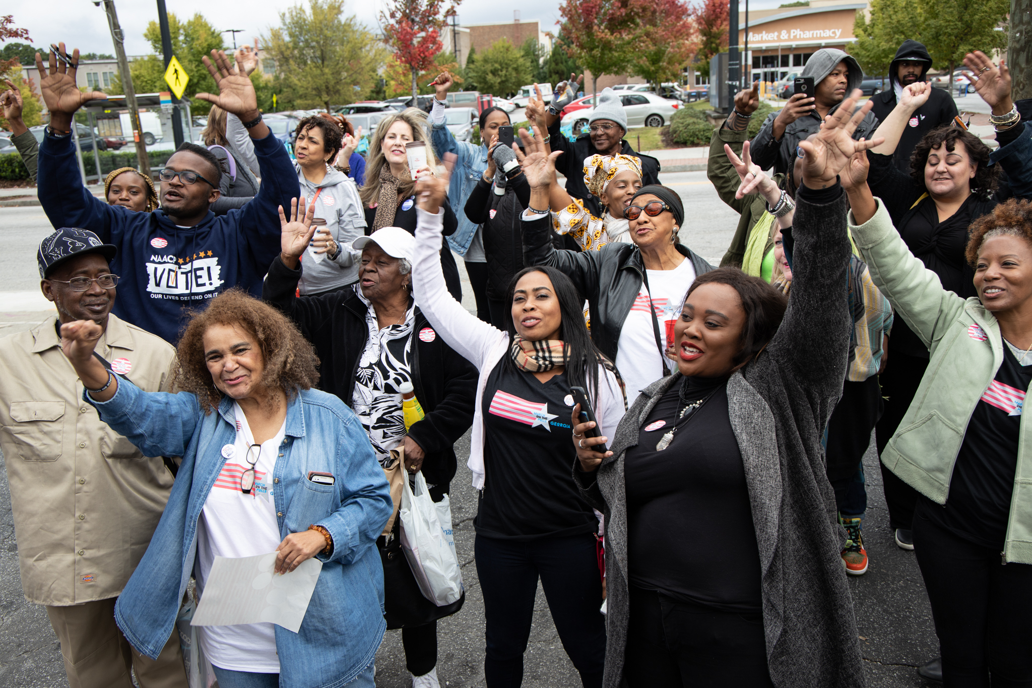 Women_and_men_raising_their_arms_in_parade Women_and_men_raising_their_arms_in_parade