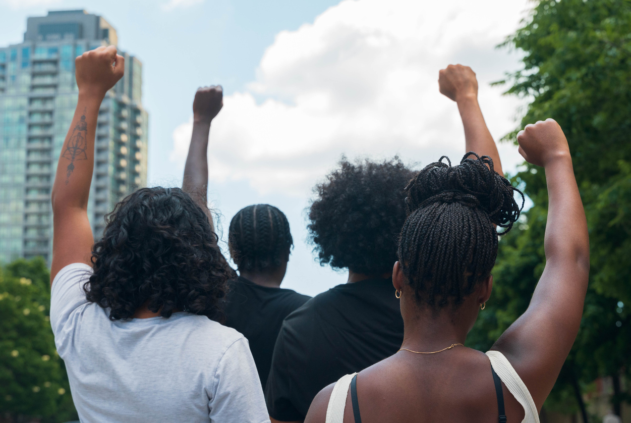 A group of African American people protest racial injustice.