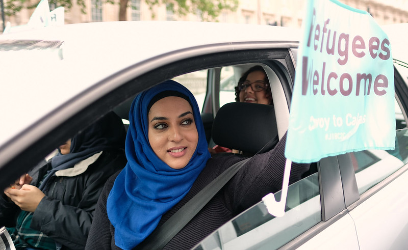 Building Welcoming Communities for Tomorrow refugees-welcome-sign-held-by-woman-driving-car
