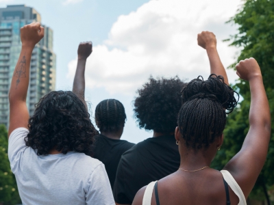 A group of African American people protest racial injustice.