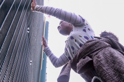 Woman standing next to fence